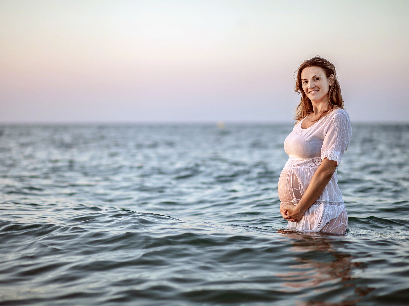 Pregnant Women Standing in Ocean - Beach Babymoon