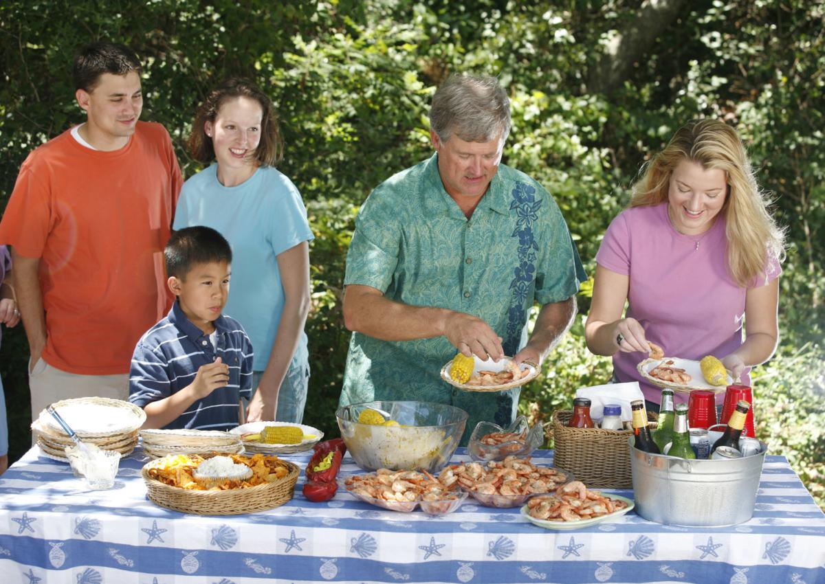 Family enjoying seafood picnic