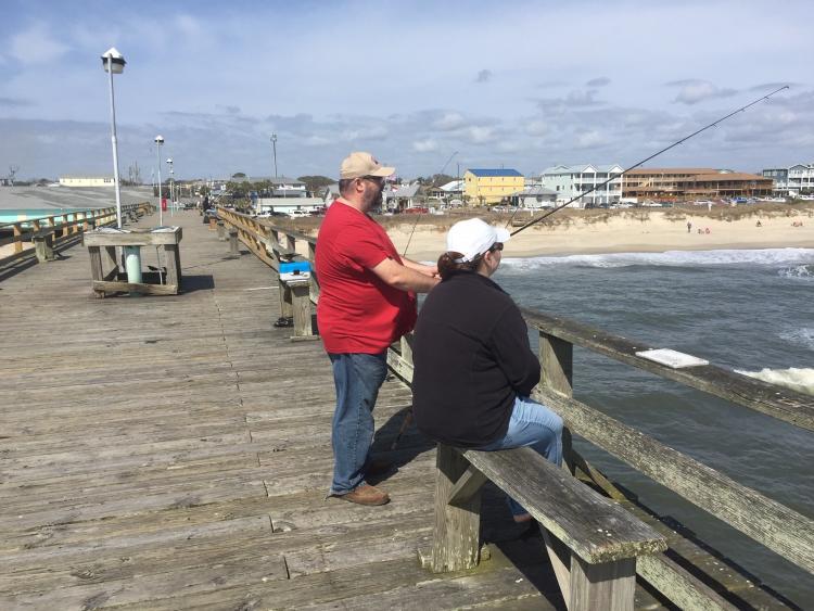 A couple fishing off the Kure Beach Fishing Pier in North Carolina